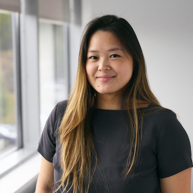 female mural employee smiling in office